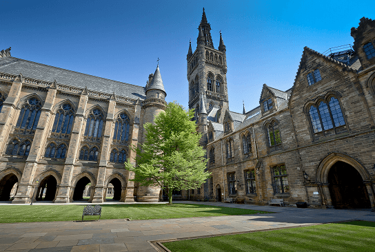 Historic university building with tower against a blue sky